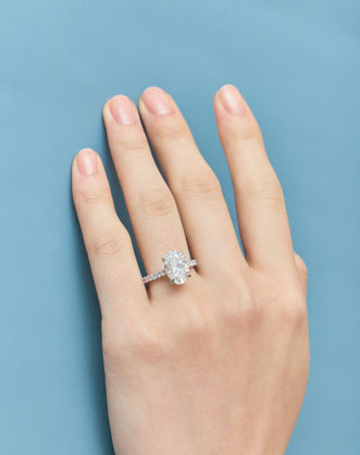 Close-up Nassau oval cut diamond band engagement ring in 18ct white gold