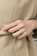 Model wears Marion emerald cut trilogy engagement ring in 18ct yellow gold