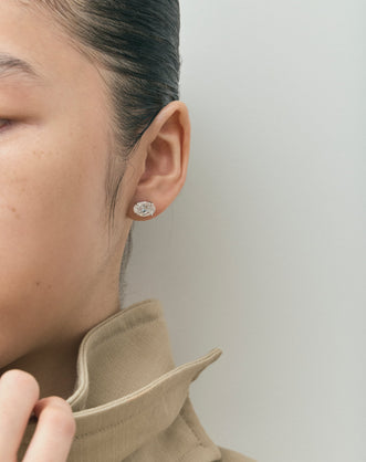 Model wears Laurel 2ct oval cut diamond studs in 18ct white gold 