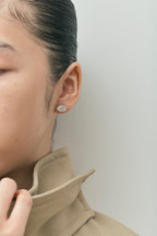 Model wears Laurel 2ct oval cut diamond studs in 18ct white gold 