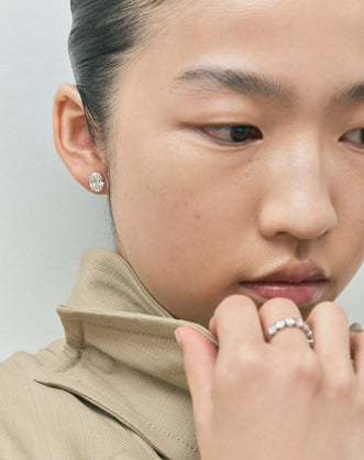 Model wears Laurel 2ct oval cut diamond studs in 18ct white gold 