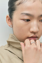Model wears Laurel 2ct oval cut diamond studs in 18ct white gold 