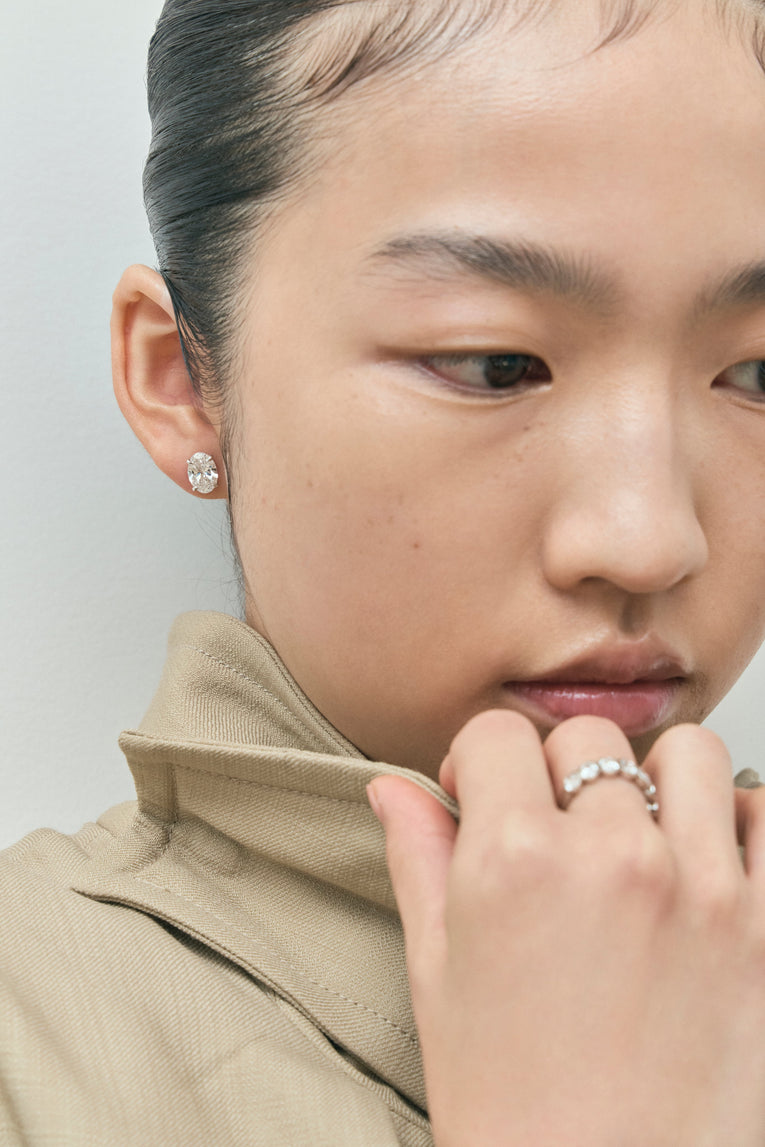 Model wears Laurel 2ct oval cut diamond studs in 18ct white gold 