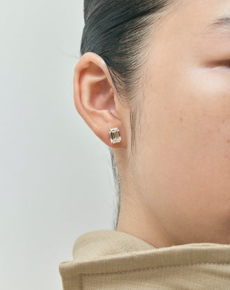 Model wears Clark 2ct emerald cut diamond studs in 18ct yellow gold