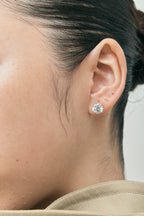Model wears Rowan 2ct round brilliant cut diamond studs in 18ct white gold