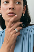 Model wears Cler 0.30ct oval half eternity band in 18ct yellow gold