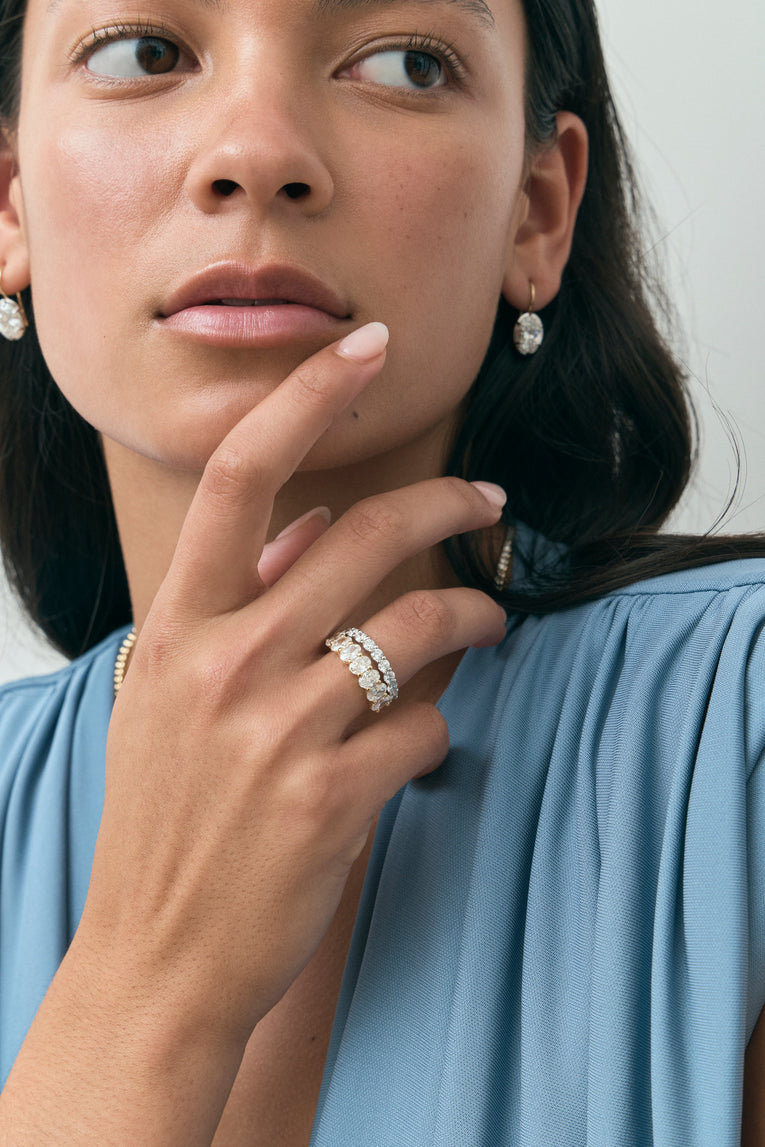 Model wears Cler 0.30ct oval half eternity band in 18ct yellow gold