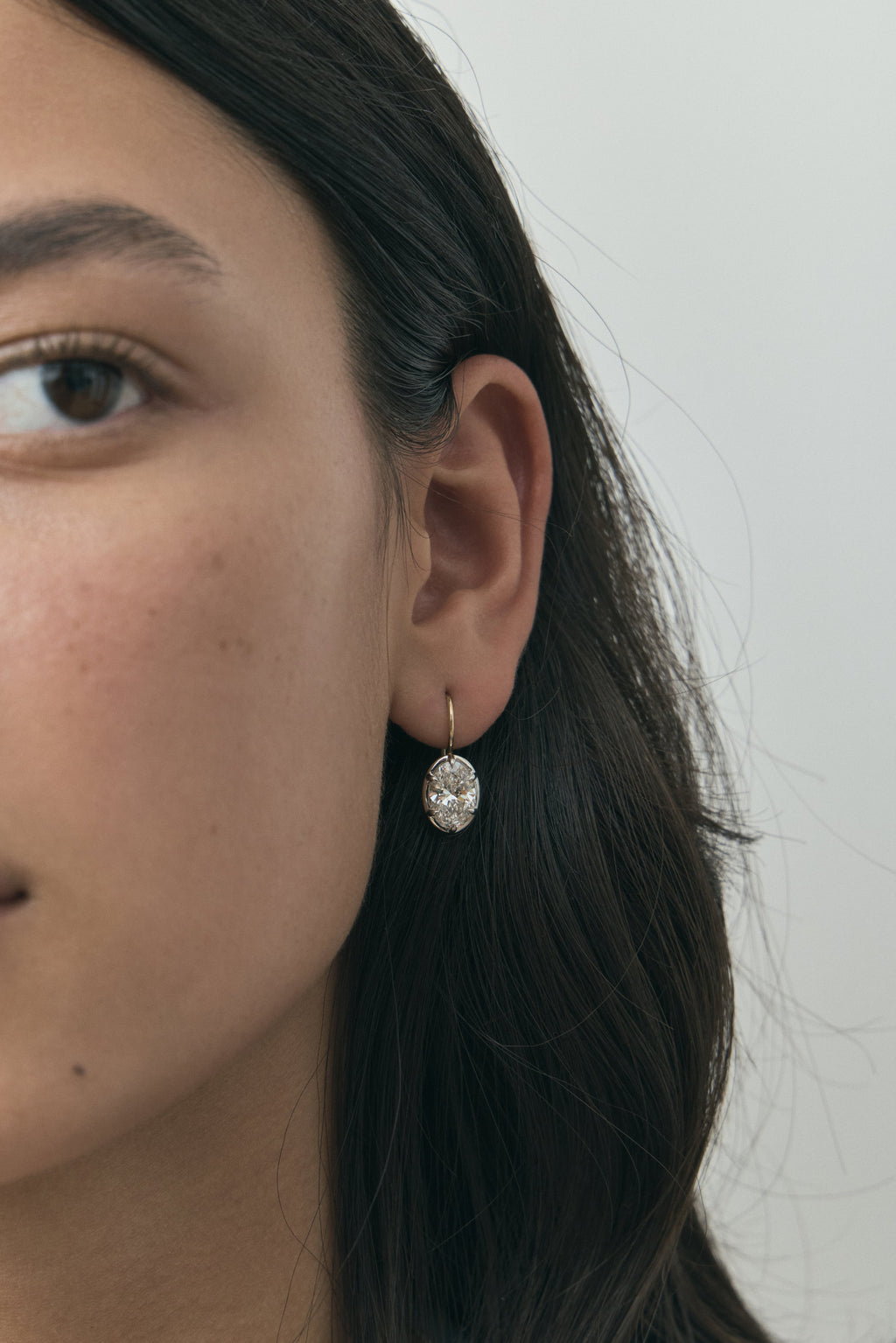 Model wears Vendôme 2ct oval button style drop earrings in 18ct yellow gold