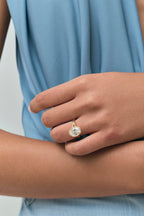 Model wears Sullivan 3ct oval solitaire bezel double band engagement ring in 18ct yellow gold