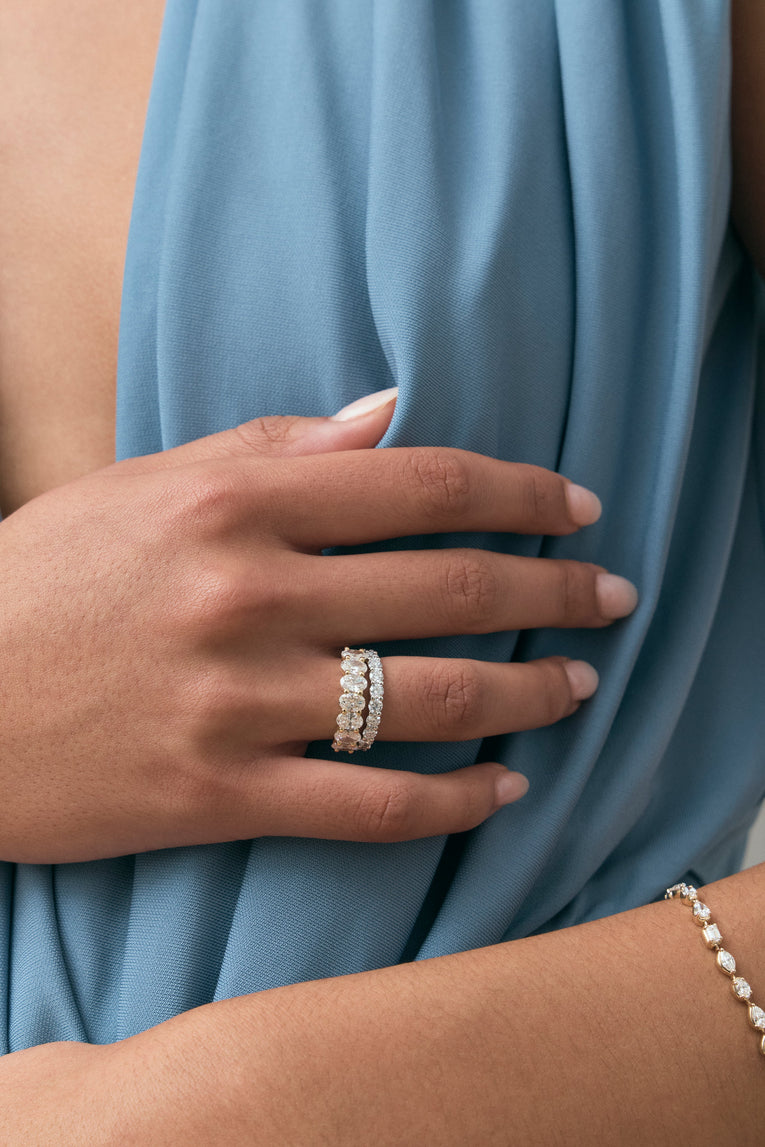 Close-up model wears Cler 0.30ct oval half eternity band in 18ct yellow gold