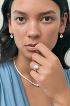 Model wears Sullivan 3ct oval solitaire bezel double band engagement ring in 18ct yellow gold