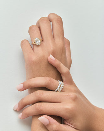 Close-up Sullivan 3ct oval solitaire bezel double band engagement ring in 18ct yellow gold