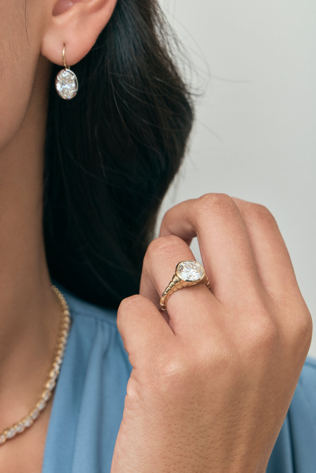 Model wears Vendôme 2ct oval button style drop earrings in 18ct yellow gold