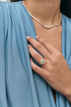 Model wears Chrystie 3ct round brilliant signet bezel grooved band engagement ring in 18ct yellow gold