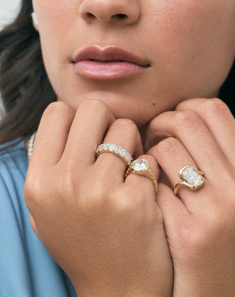 Model wears Prince 3ct radiant cut curved band engagement ring in 18ct yellow gold