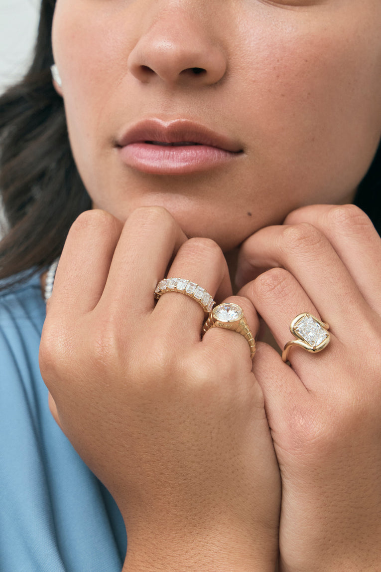 Model wears Prince 3ct radiant cut curved band engagement ring in 18ct yellow gold