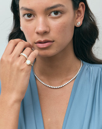 Model wears Moncur 1.5ct pear cut diamond studs in 18ct white gold