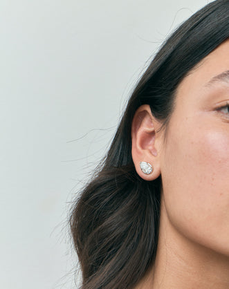 Model wears Moncur 1.5ct pear cut diamond studs in 18ct white gold