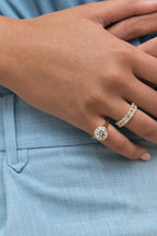 Close-up model wears Soho 0.30ct emerald cut half eternity band in 18ct yellow gold