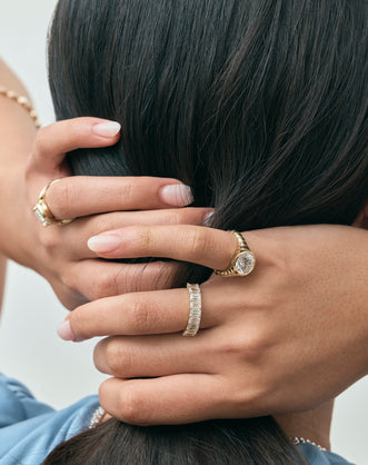 Model wears Soho 0.30ct emerald cut half eternity band in 18ct yellow gold