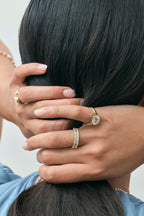 Model wears Soho 0.30ct emerald cut half eternity band in 18ct yellow gold