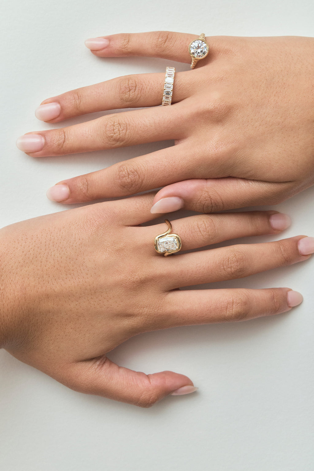 Close-up model wears Soho 0.30ct emerald cut half eternity band in 18ct yellow gold