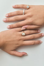 Close-up model wears Soho 0.30ct emerald cut half eternity band in 18ct yellow gold
