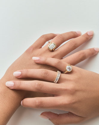 Model wears Prince 3ct radiant cut curved band engagement ring in 18ct yellow gold