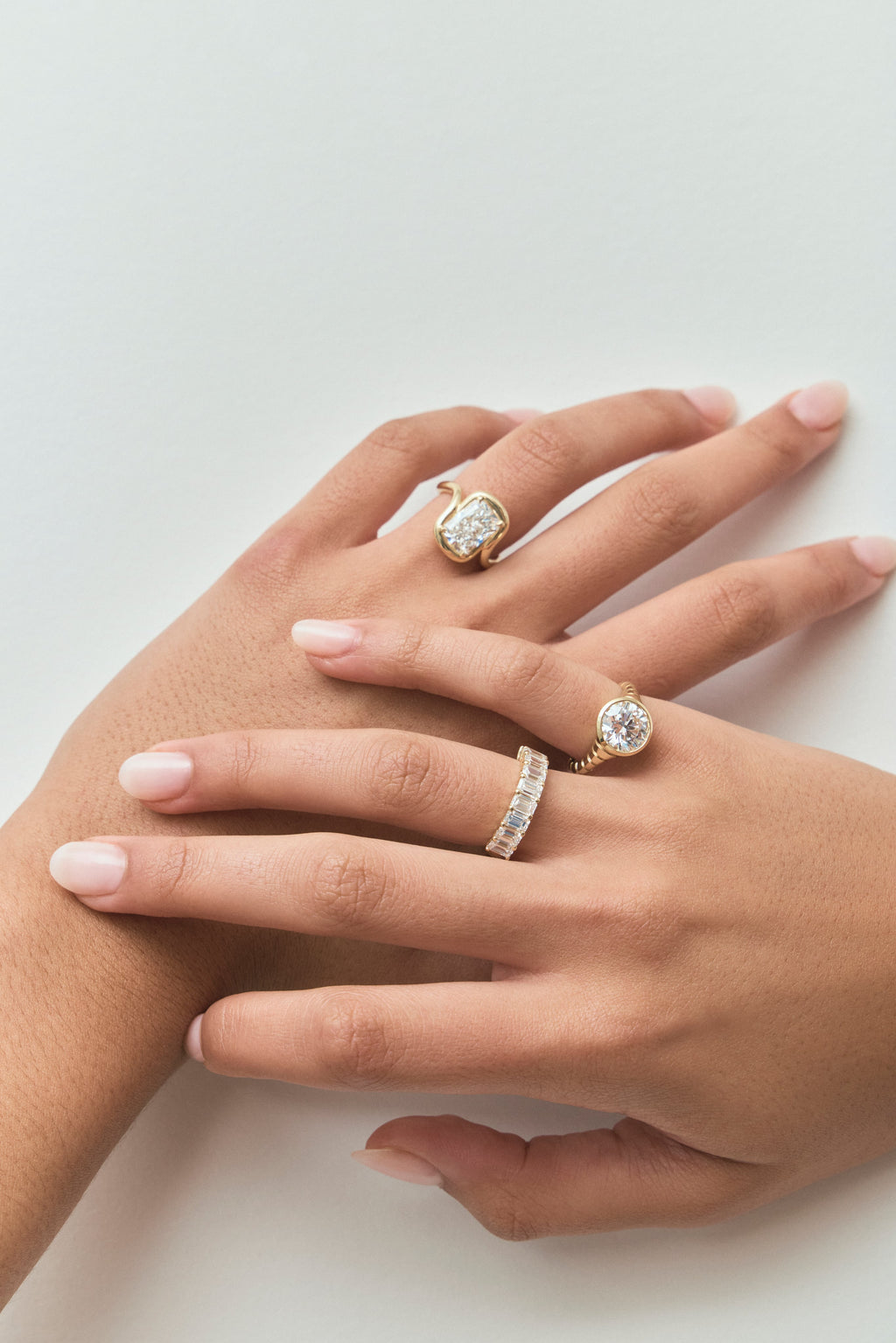 Model wears Prince 3ct radiant cut curved band engagement ring in 18ct yellow gold