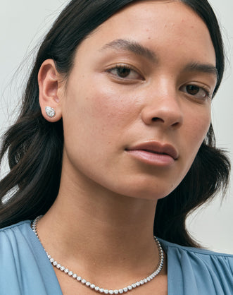 Model wears Moncur 1.5ct pear cut diamond studs in 18ct white gold