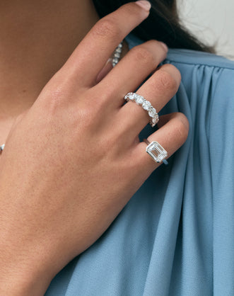 Close-up model wears Cheyne 0.50ct round brilliant half eternity band in 18ct white gold