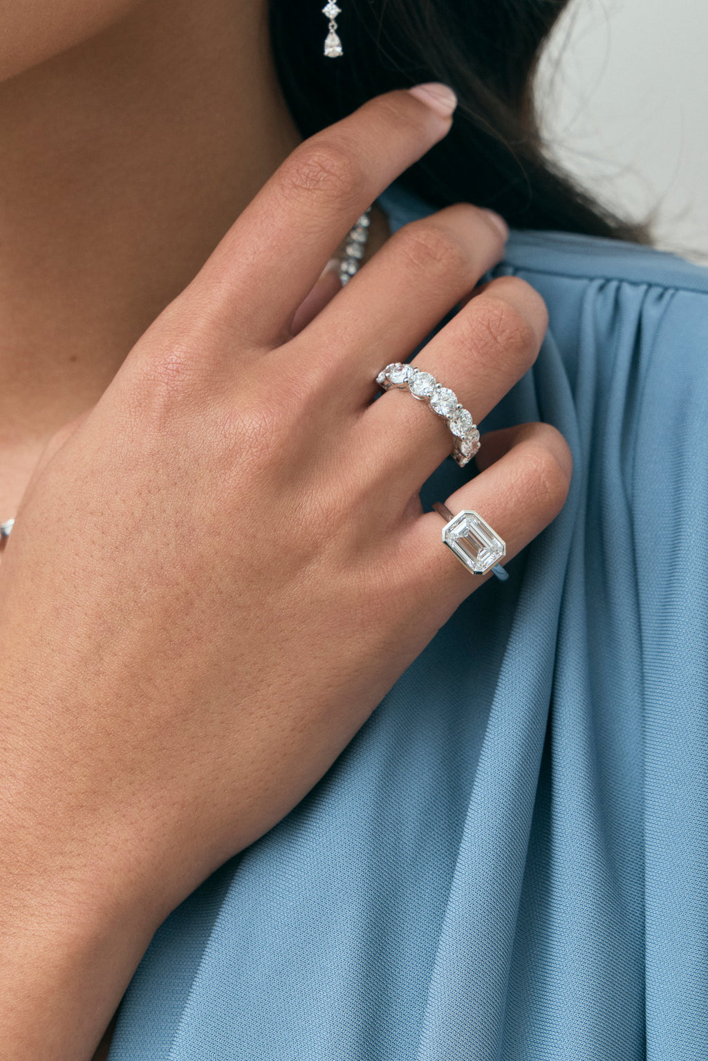 Close-up model wears Cheyne 0.50ct round brilliant half eternity band in 18ct white gold