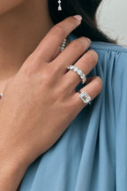 Close-up model wears Cheyne 0.50ct round brilliant half eternity band in 18ct white gold