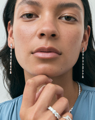 Model wears Tribeca mixed shape statement drop earrings in 18ct white gold