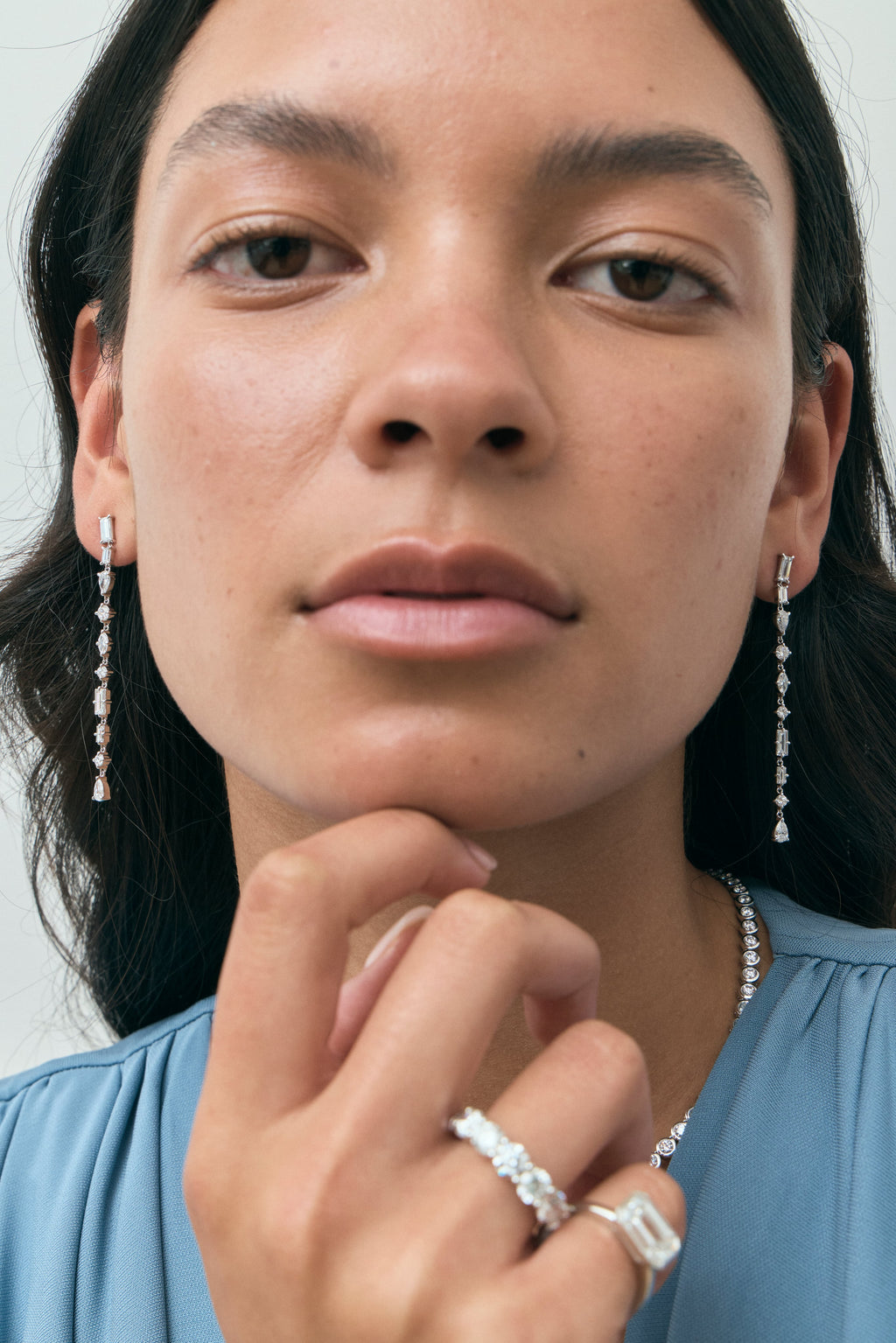 Model wears Tribeca mixed shape statement drop earrings in 18ct white gold