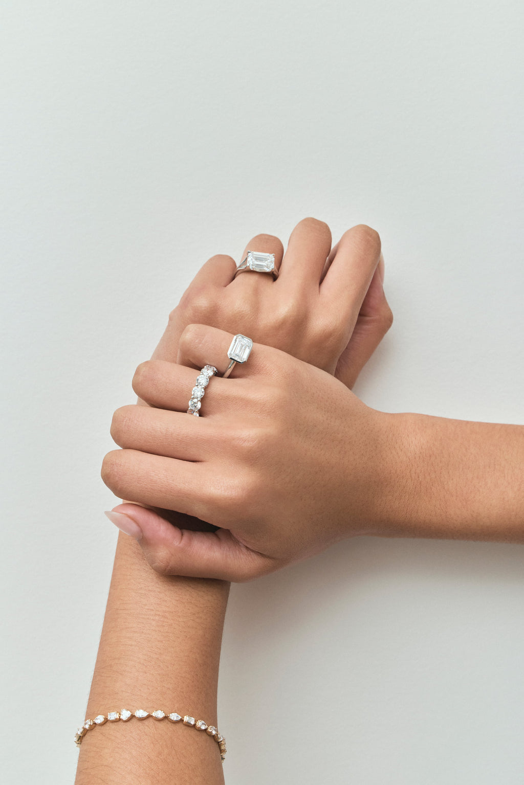Close-up model wears Cheyne 0.50ct round brilliant half eternity band in 18ct white gold