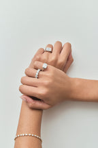 Close-up model wears Cheyne 0.50ct round brilliant half eternity band in 18ct white gold