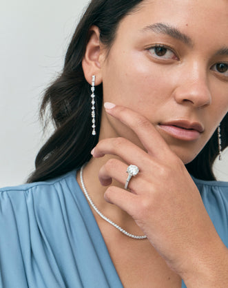 Model wears Hudson 4ct round brilliant tapered baguette engagement ring in platinum
