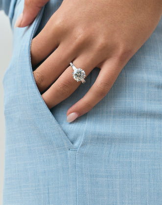Model wears Hudson 4ct round brilliant tapered baguette engagement ring in 18ct white gold