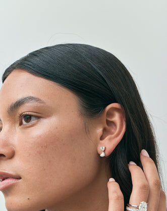 Model wears Notting romantic pair double 0.50ct heart shape drop earrings in 18ct yellow gold