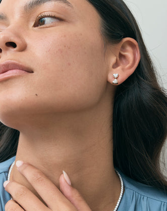 Model wears Notting romantic pair double 0.50ct heart shape drop earrings in 18ct yellow gold