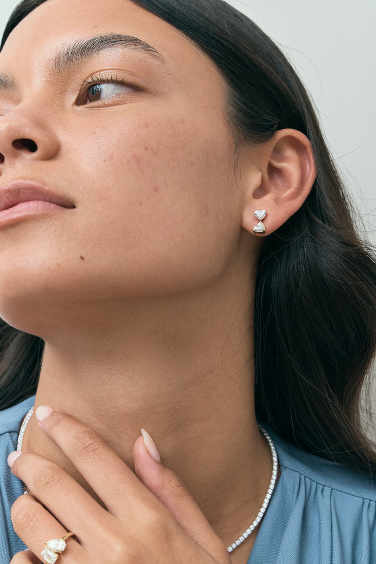 Model wears Notting romantic pair double 0.50ct heart shape drop earrings in 18ct yellow gold