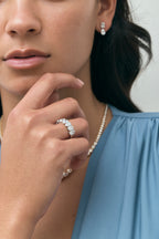 Close-up model wears Cler 0.50ct oval half eternity band in 18ct white gold