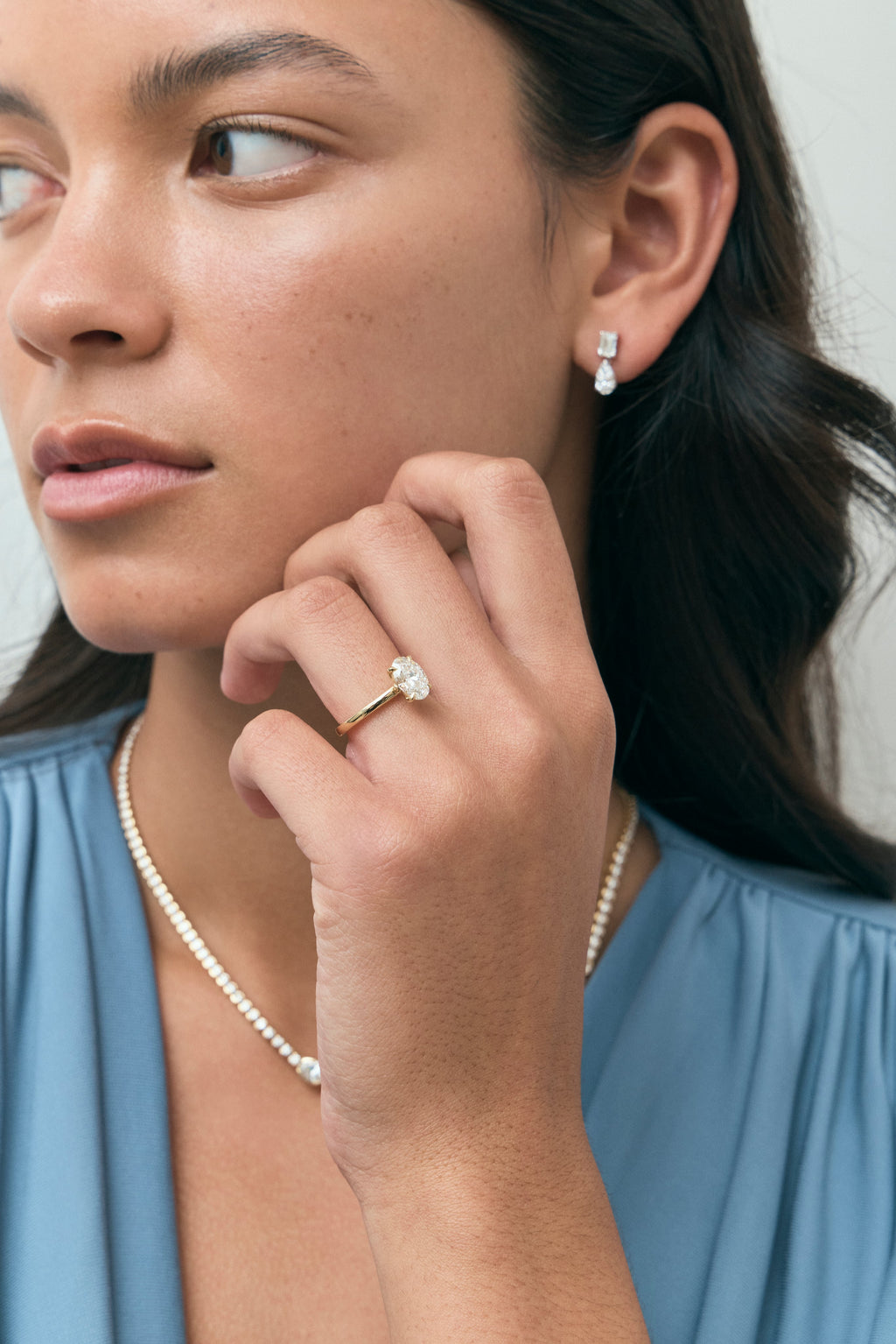 Model wears Florence oval solitaire classic engagement ring in 18ct yellow gold