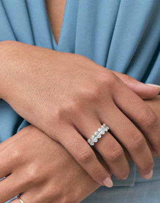 Close-up model wears Cler 0.50ct oval half eternity band in platinum