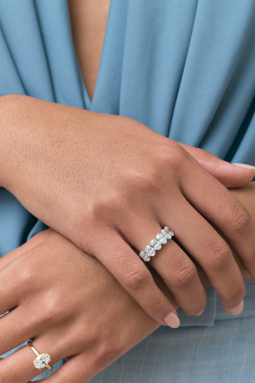 Close-up model wears Cler 0.50ct oval half eternity band in platinum