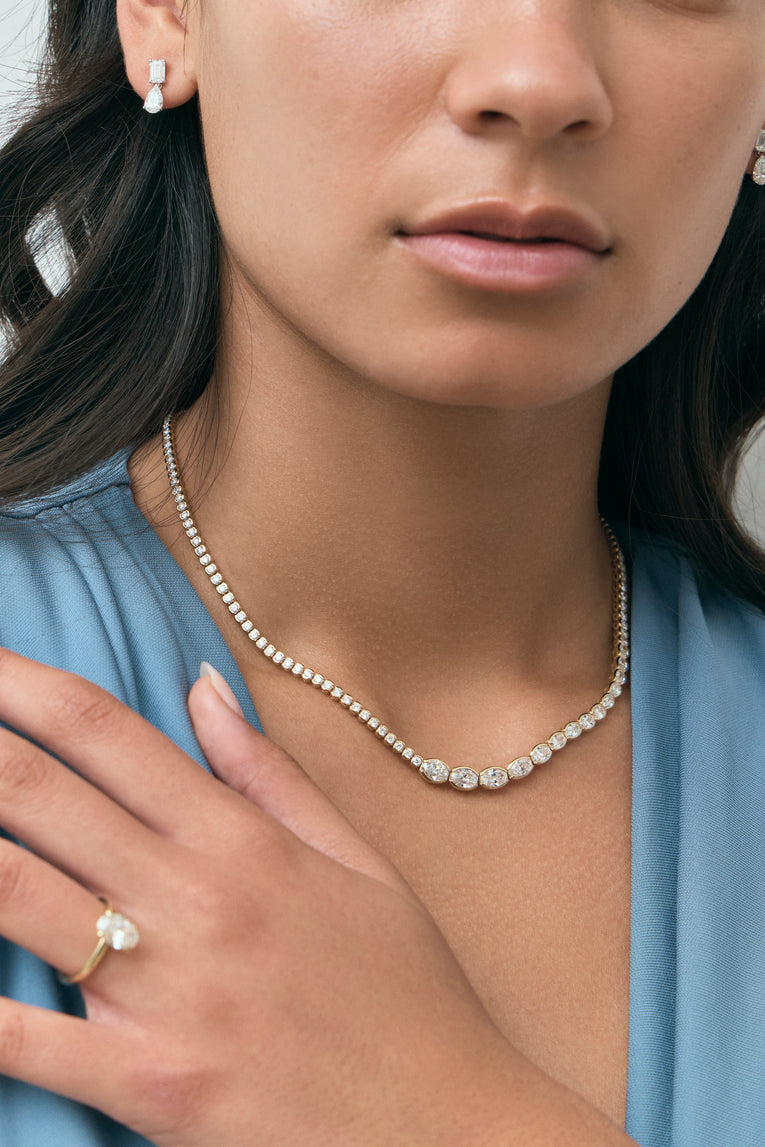 Model wears Mateo Semi bezel graduated necklace in 18ct yellow gold