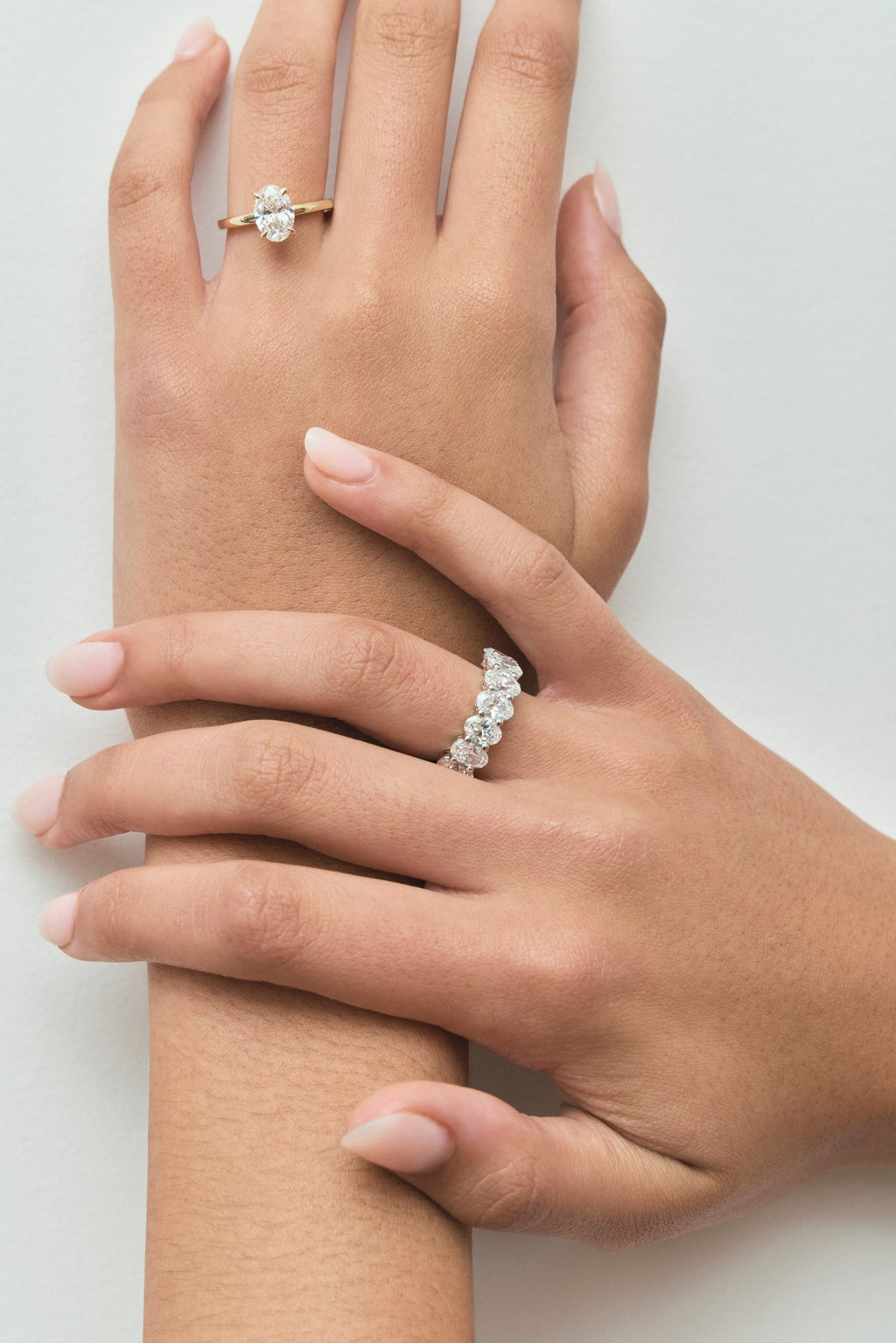 Model wears Model wears Florence oval solitaire classic engagement ring in 18ct yellow gold