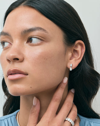 Model wears Cler 0.50ct oval half eternity band in 18ct white gold