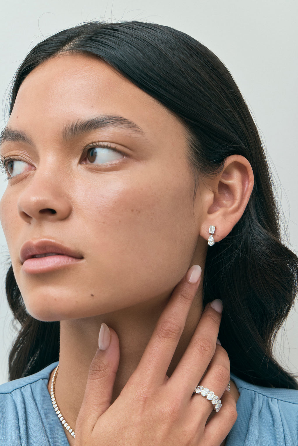 Model wears Cler 0.50ct oval half eternity band in 18ct white gold